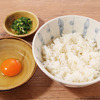 Carefully prepared rice with raw egg on top of it