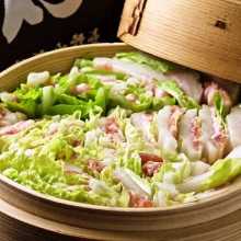 Vegetables and pork steamed in a bamboo steamer