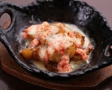 Grilled potatoes and marinated cod roe with cheese