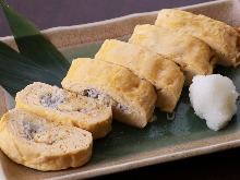 Japanese-style rolled omelet with whitebait and green onion