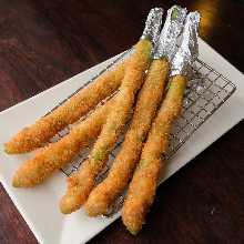 Fried pork wrapped asparagus skewer