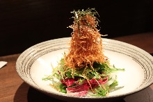 Salad topped with crispy fried noodles