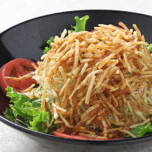 Salad topped with crispy fried noodles