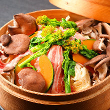 Vegetables and pork steamed in a bamboo steamer