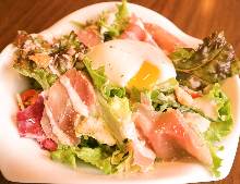 Caesar salad with soft-boiled egg and prosciutto