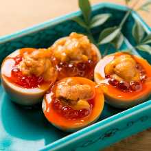 A dish of soft-boiled eggs topped with sea urchin and salmon roe A dish of soft-boiled eggs topped with sea urchin and salmon roe