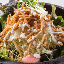 Salad topped with crispy fried noodles