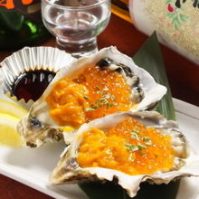 Raw oysters topped with sea urchin and salmon roe