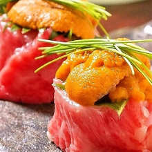 Horse meat nigiri sushi topped with sea urchin