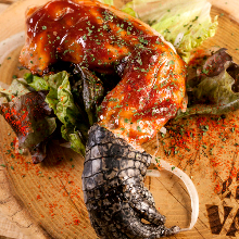 Grilled crocodile meat with garlic