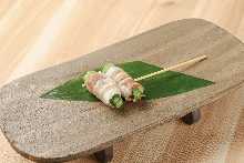 Grilled pork wrapped vegetable skewer