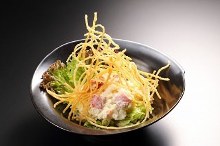 Salad topped with crispy fried noodles