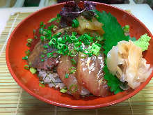 Seafood rice bowl with dashi sauce and grated daikon radish