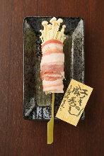 Grilled pork wrapped enoki mushroom skewer