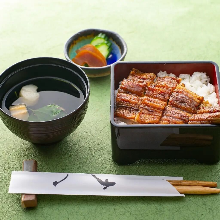 gold Eel served over rice in a lacquered box Half a eel