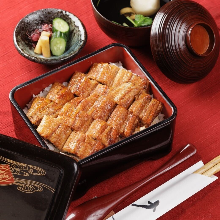 gold Eel served over rice in a lacquered box One eel