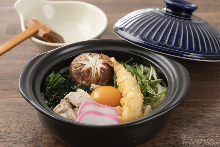 Wheat noodles boiled in a ceramic pot