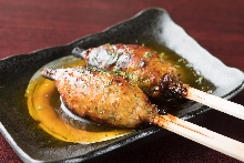 Grilled meatball skewer with egg yolk