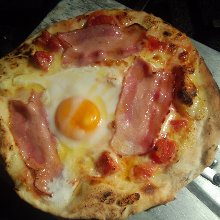 Carbonara pizza with soft boiled egg