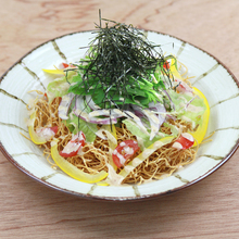 Salad topped with crispy fried noodles
