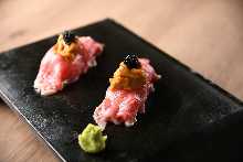 Beef nigiri sushi topped with sea urchin