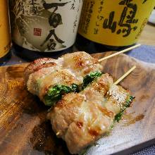 Grilled and skewered green onions wrapped in pork