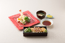 Tempura and steak over rice in a laquered box with tempura set