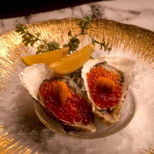 Raw oysters topped with sea urchin and salmon roe