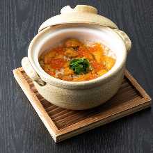 Sea urchin and salmon roe rice cooked in an earthenware pot