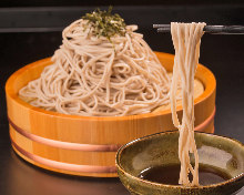 Wild yam buckwheat noodles served on a bamboo strainer with agodashi (flying fish broth) soup
