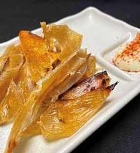 Charcoal-seared ray fin