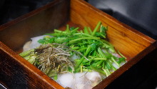 Duck steamed in a bamboo steamer