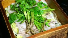 Pork steamed in a bamboo steamer