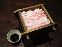 Pork steamed in a bamboo steamer