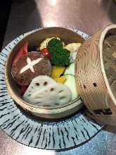 Vegetables steamed in a bamboo steamer