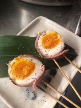 Bacon wrapped soft boiled egg skewer
