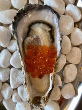 Raw oysters topped with salmon roe