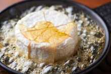 Whole camembert cheese baked in honey oven