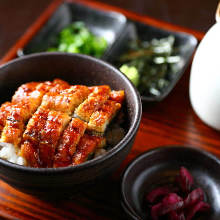 a bowl of finely sliced and broiled on top of rice